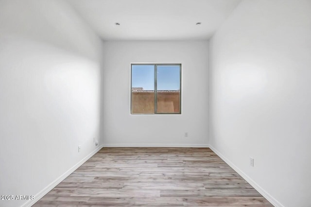 unfurnished room with light wood-type flooring