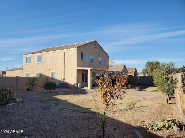 rear view of house featuring cooling unit