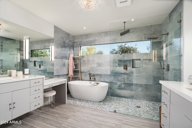 bathroom featuring vanity, independent shower and bath, and tile walls