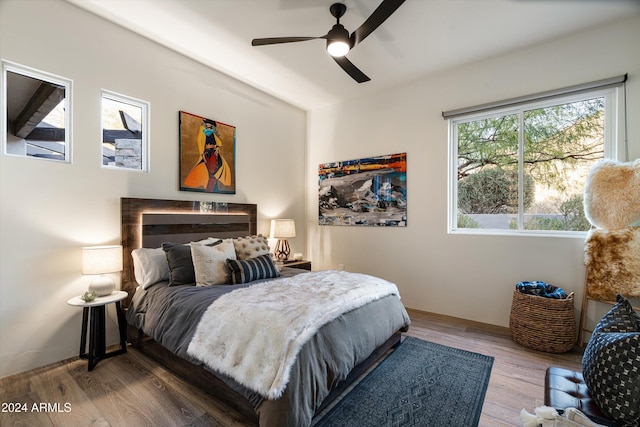 bedroom with wood-type flooring and ceiling fan