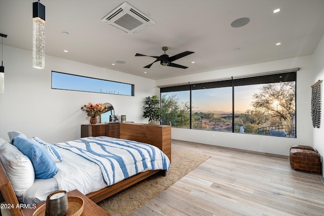 bedroom featuring light hardwood / wood-style floors and ceiling fan