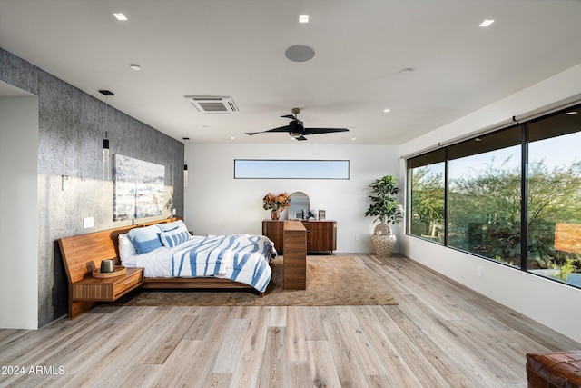 bedroom with ceiling fan and light hardwood / wood-style flooring