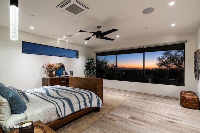 bedroom with ceiling fan and light hardwood / wood-style flooring