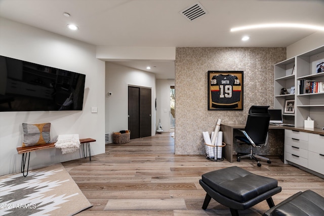 office area with light hardwood / wood-style floors