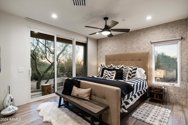 bedroom featuring ceiling fan, wood-type flooring, and access to outside