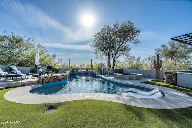 view of swimming pool with an in ground hot tub, pool water feature, a lawn, and a patio