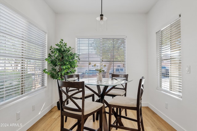 dining space with plenty of natural light and light hardwood / wood-style flooring