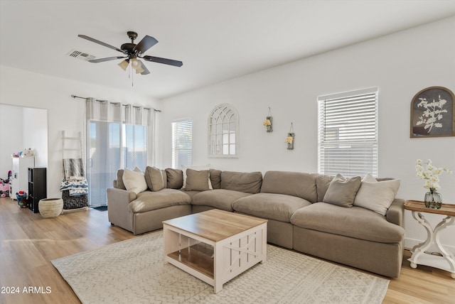 living room with light hardwood / wood-style floors, plenty of natural light, and ceiling fan