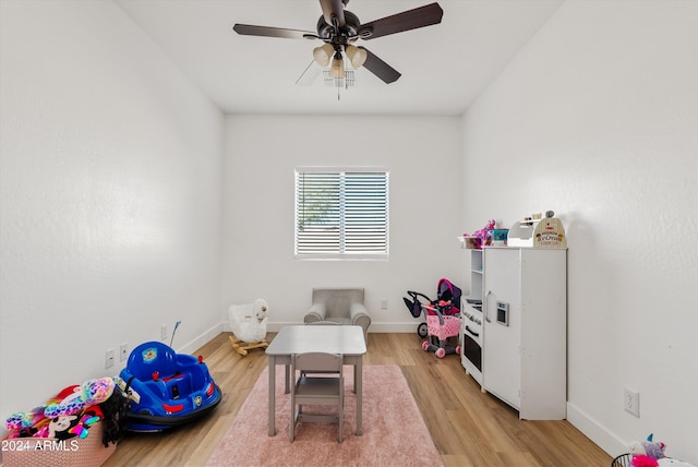 recreation room featuring light hardwood / wood-style floors and ceiling fan