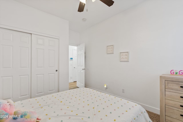 bedroom featuring ceiling fan, a closet, and carpet