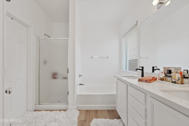 bathroom with hardwood / wood-style flooring, vanity, and independent shower and bath