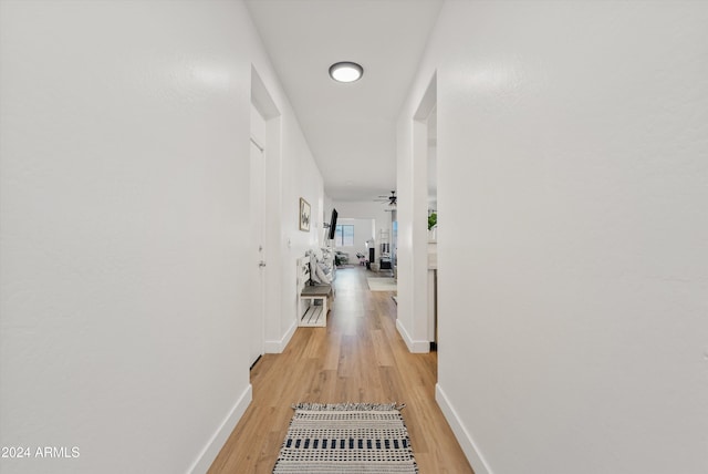 hallway with light hardwood / wood-style floors