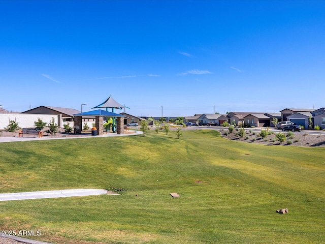 surrounding community with a gazebo, a residential view, and a lawn
