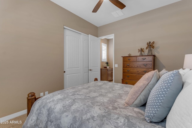 carpeted bedroom with ceiling fan and a closet