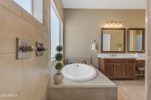 bathroom with vanity, tile patterned floors, and tiled bath