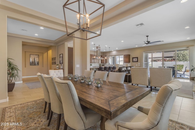 dining room with ceiling fan with notable chandelier and light hardwood / wood-style flooring