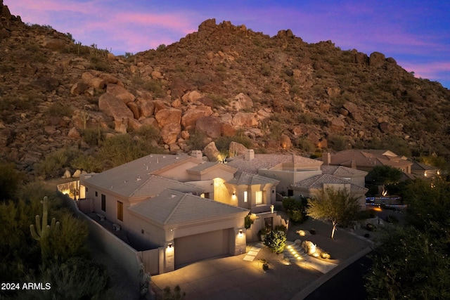 aerial view at dusk featuring a mountain view