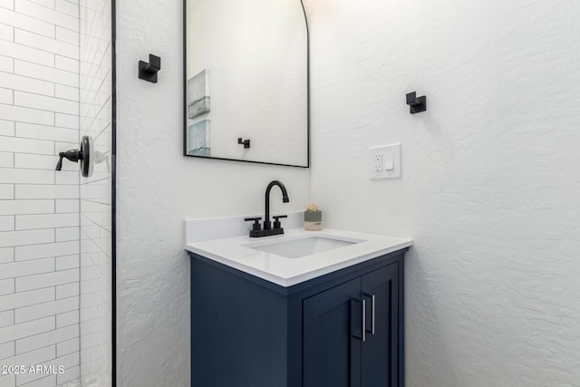 48 S Catalina St, Gilbert, AZ 85233 - bathroom with vanity, a textured wall, and tiled shower
