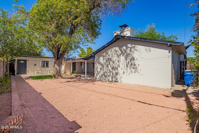 48 S Catalina St, Gilbert, AZ 85233 - rear view of house featuring a chimney and brick siding