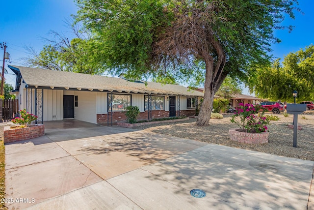 48 S Catalina St, Gilbert, AZ 85233 - ranch-style house featuring driveway, board and batten siding, a carport, and brick siding