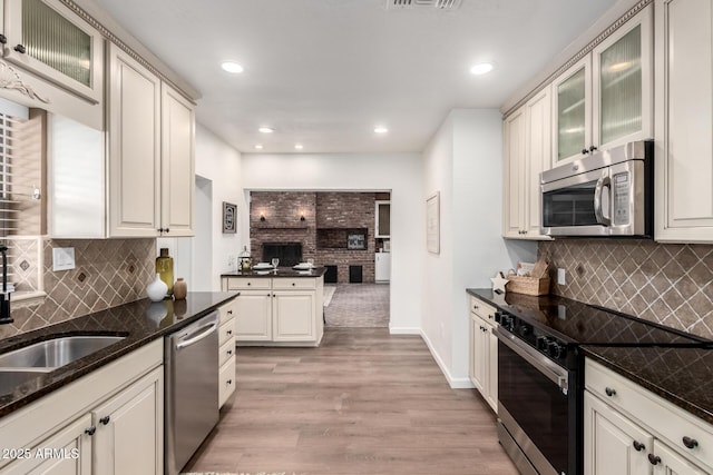 48 S Catalina St, Gilbert, AZ 85233 - kitchen featuring appliances with stainless steel finishes, light wood-type flooring, open floor plan, decorative backsplash, and recessed lighting