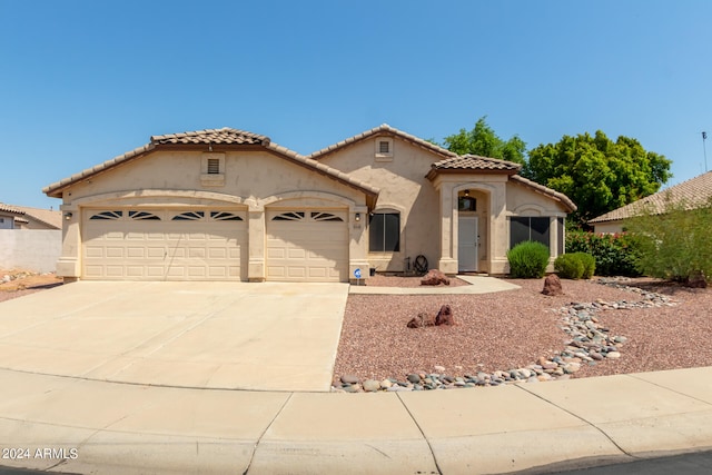 mediterranean / spanish home featuring a garage