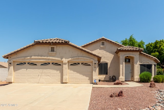 mediterranean / spanish-style home featuring a garage