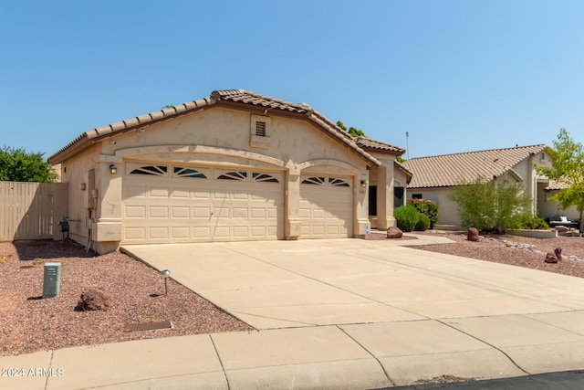 mediterranean / spanish house with a garage