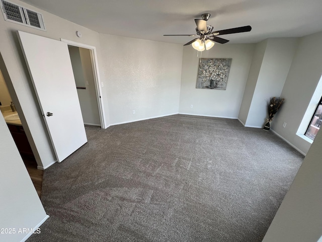 carpeted spare room featuring ceiling fan