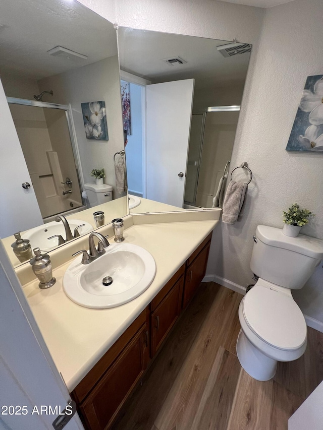 bathroom featuring hardwood / wood-style flooring, vanity, and toilet