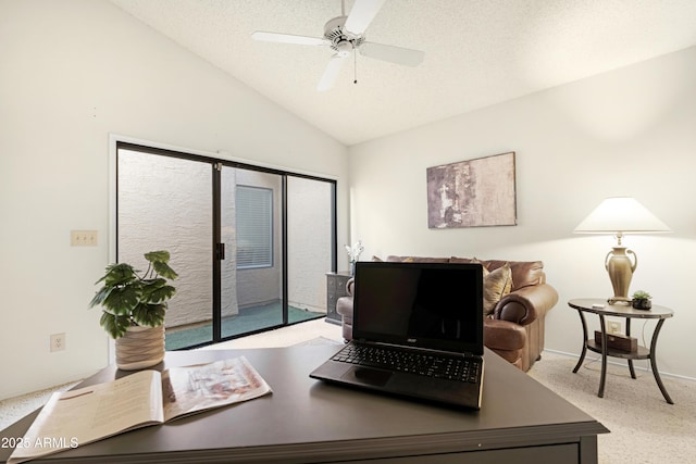 office space featuring a textured ceiling, light carpet, lofted ceiling, and ceiling fan