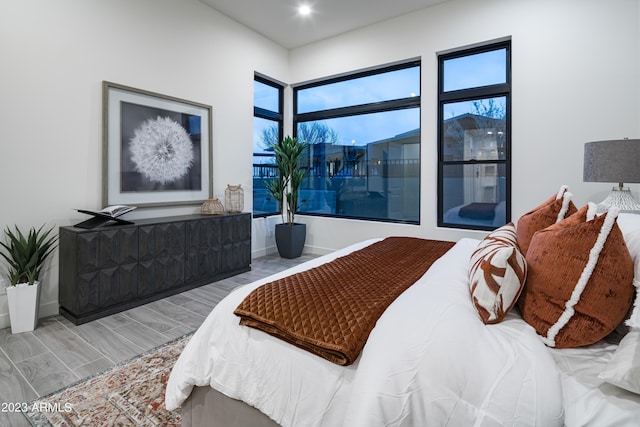 bedroom with baseboards and wood tiled floor