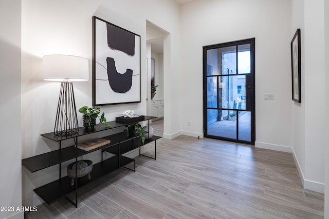 entryway with wood finished floors and baseboards