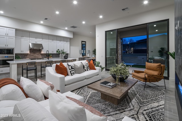 living area featuring visible vents and recessed lighting