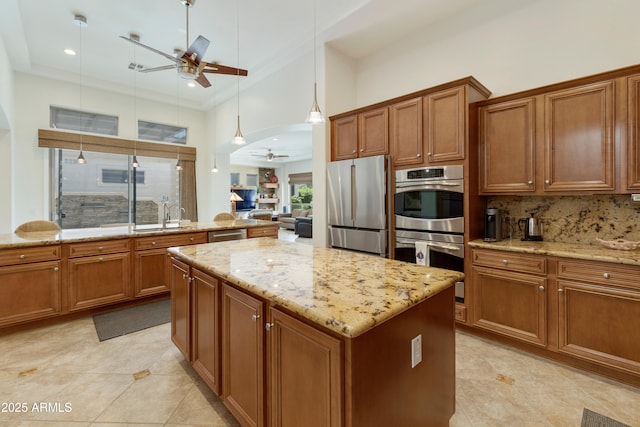 4229 E Nightingale Ln, Gilbert, AZ 85298 - kitchen featuring ceiling fan, stainless steel appliances, brown cabinets, a kitchen island, and recessed lighting