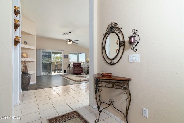 tiled entrance foyer with ceiling fan and vaulted ceiling