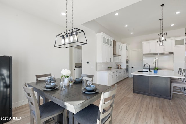 dining space featuring sink and light hardwood / wood-style floors