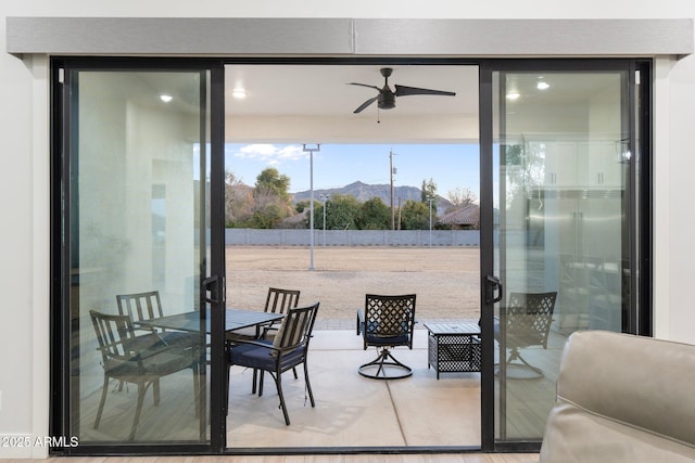 exterior space featuring a mountain view and ceiling fan