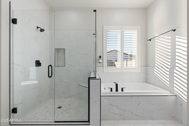 bathroom featuring shower with separate bathtub