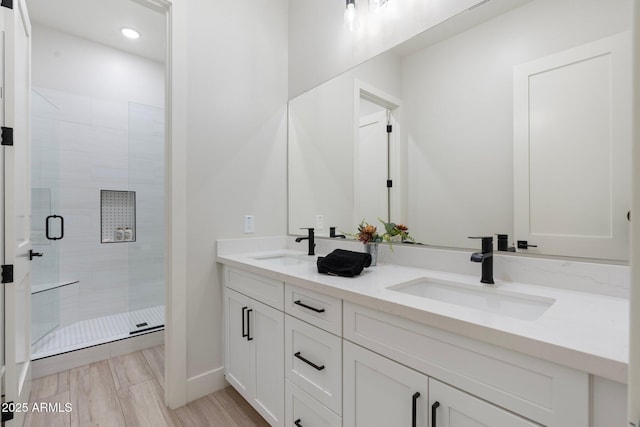 bathroom featuring vanity and an enclosed shower