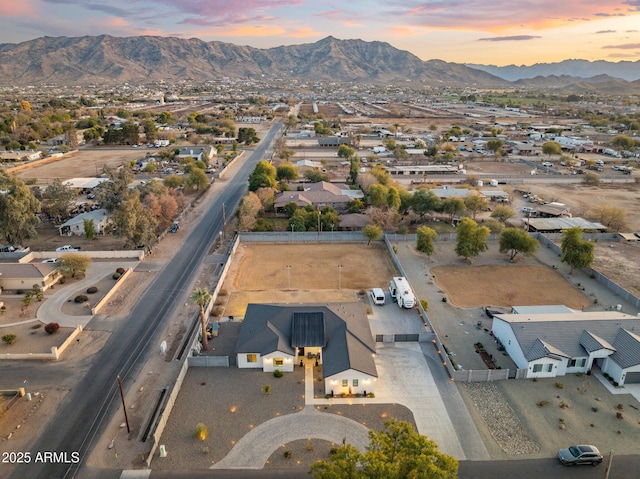 aerial view at dusk featuring a mountain view