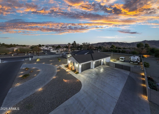 view of front of house featuring a garage and a mountain view