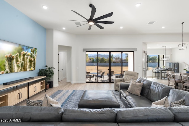 living room featuring ceiling fan and light wood-type flooring