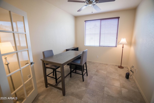 office space featuring ceiling fan and baseboards