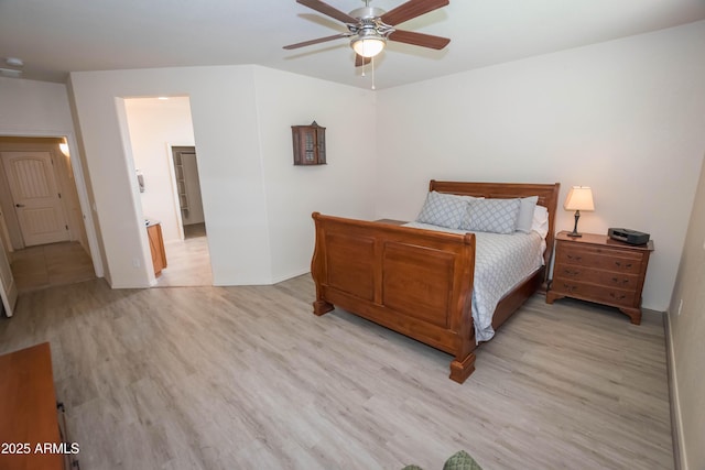 bedroom with a ceiling fan, light wood-style flooring, and baseboards