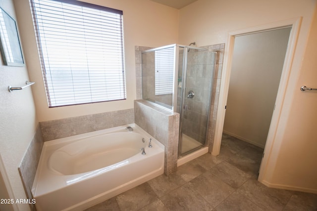 bathroom featuring a shower stall and a bath