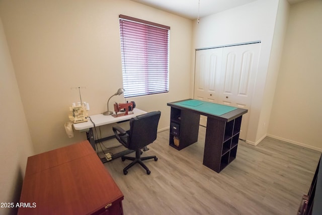 home office with light wood finished floors and baseboards
