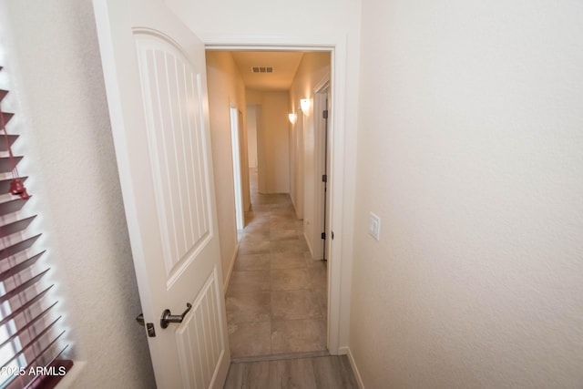 corridor with tile patterned flooring and visible vents