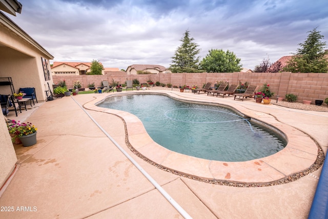 view of swimming pool featuring a patio, a fenced in pool, and a fenced backyard