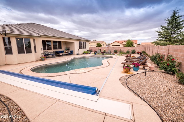 view of swimming pool with a patio area, a fenced in pool, and a fenced backyard